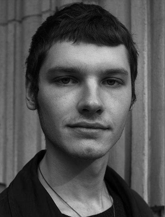 headshot of young man with dark hair